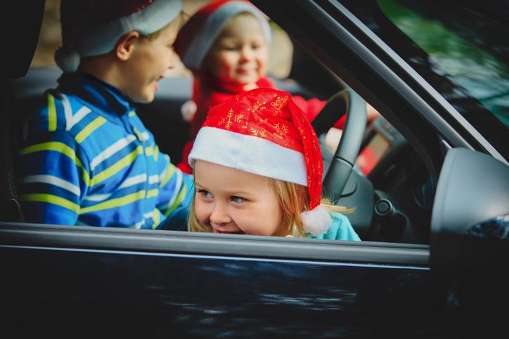 christmas car travel- happy kids travel by car in winter